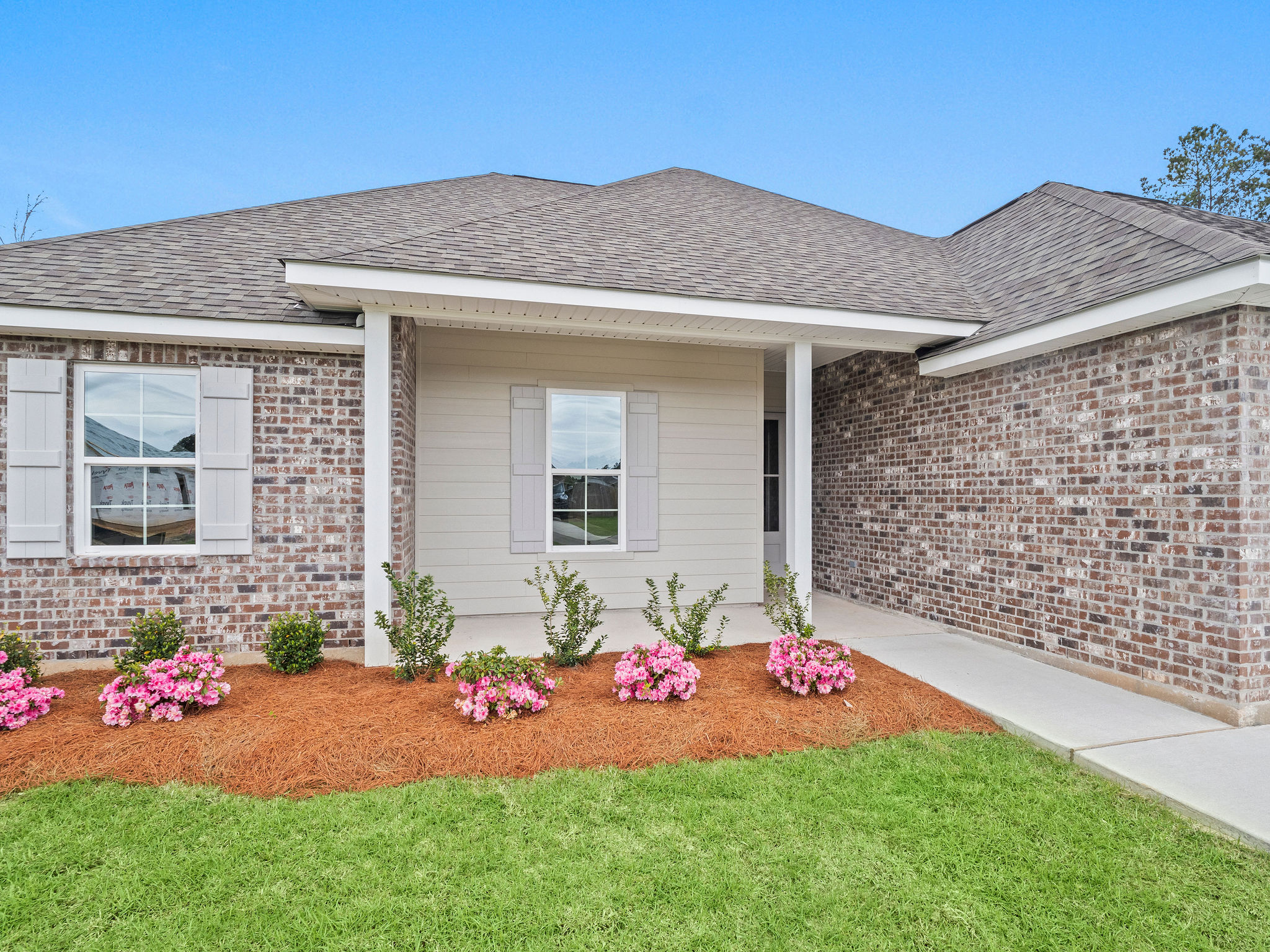 Custom home features include brick, Hardie plank siding, and fixed shutters.