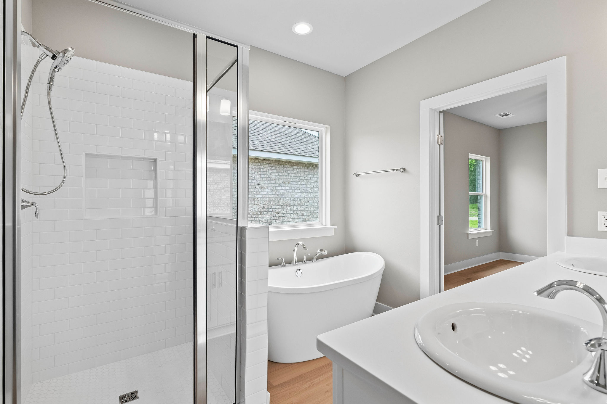 Primary bathroom suite with freestanding soaking tub and walk-in shower