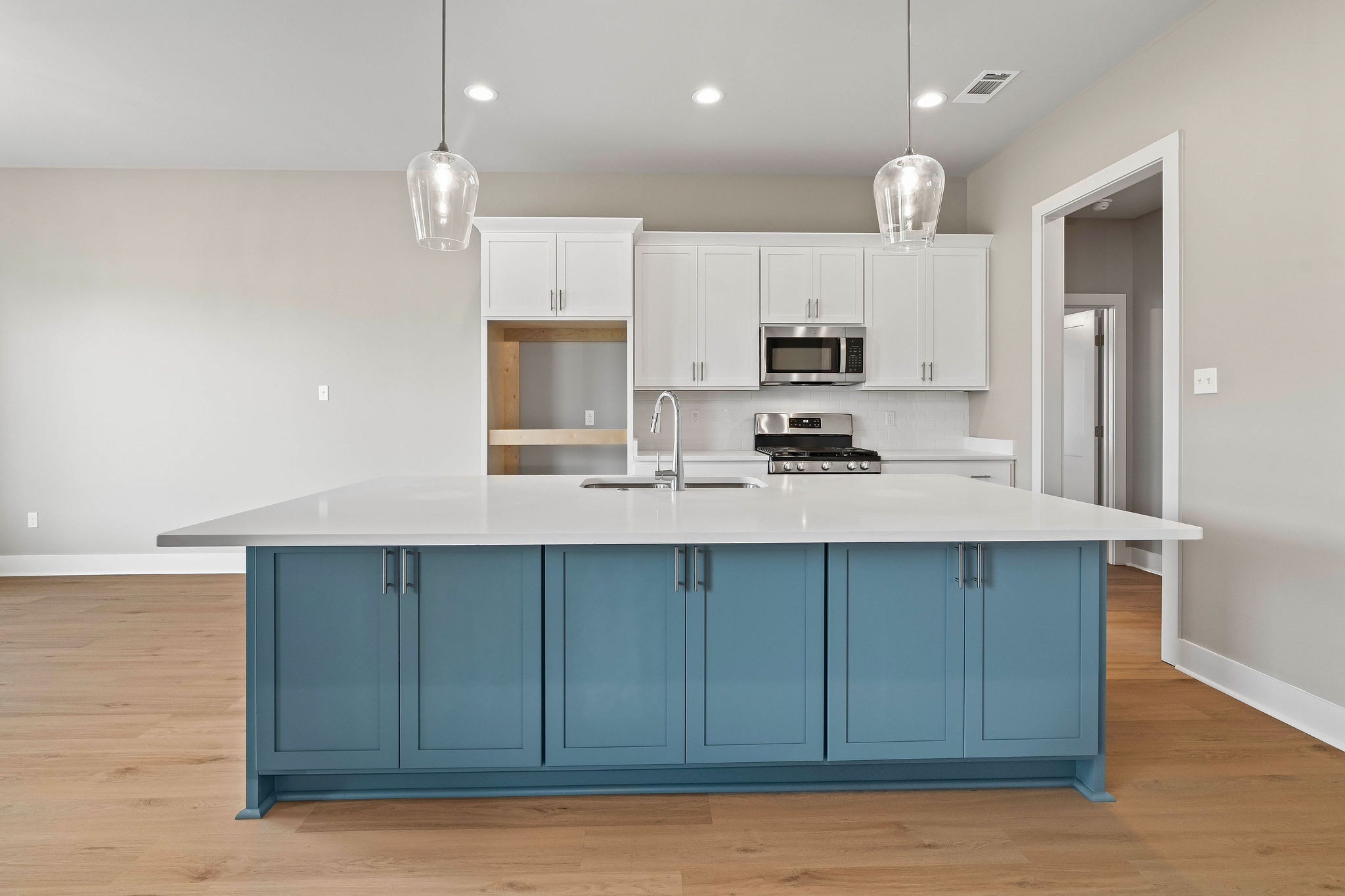 Large custom kitchen with beautiful blue island perfect for breakfast