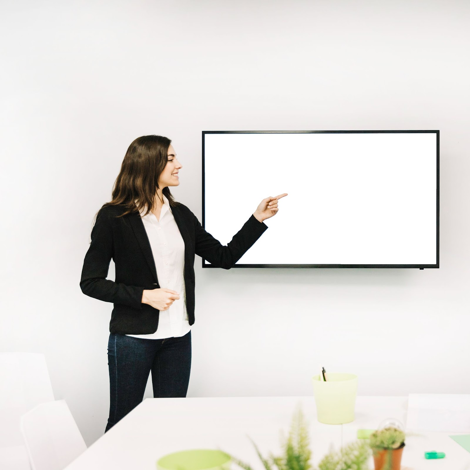 A woman pointing on a smart board