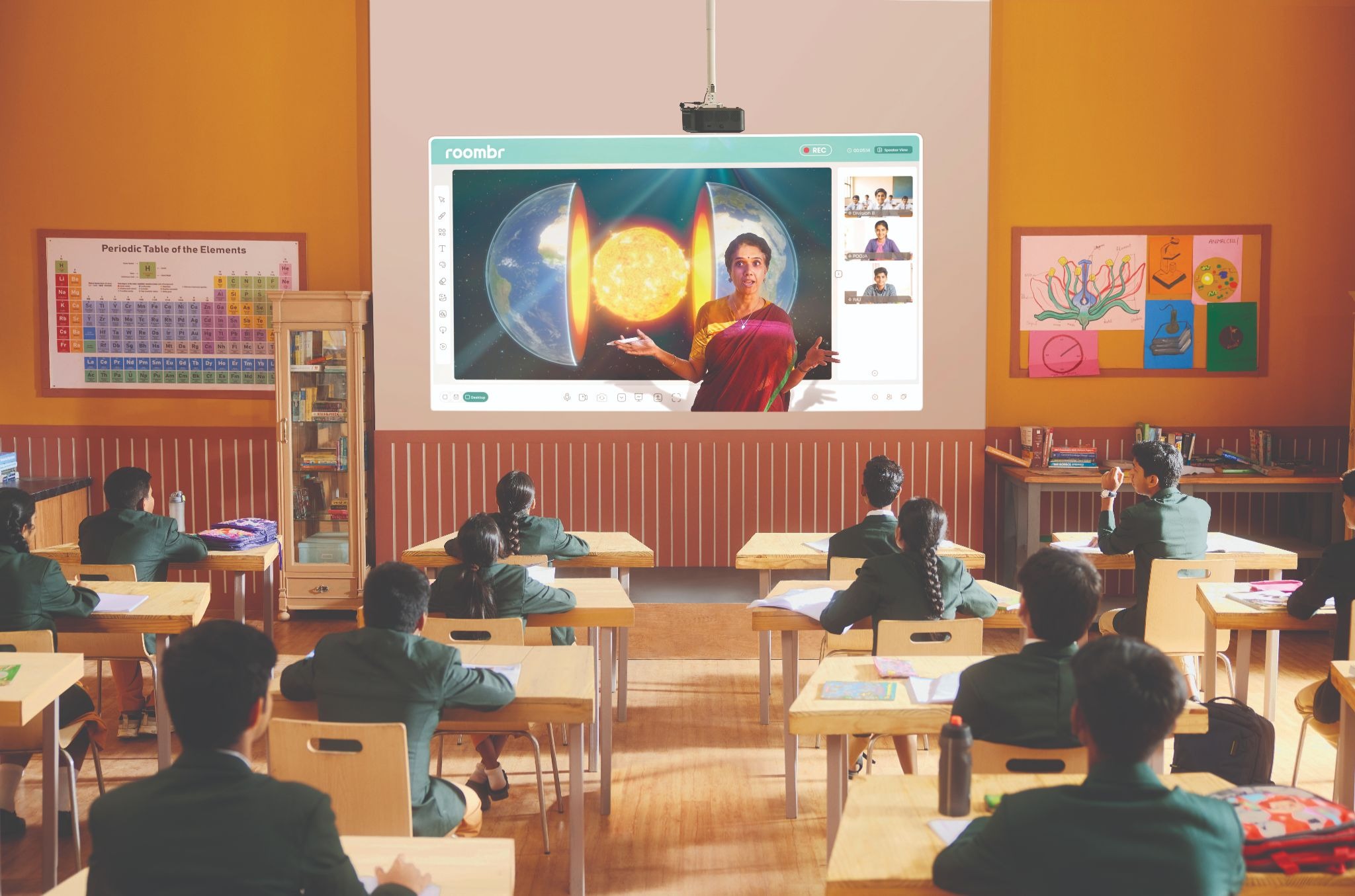 A digital classroom image showing teacher and the interactive display together in a hybrid setting 