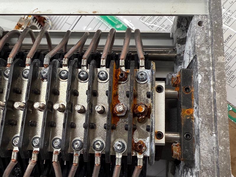 Corroded slip ring stack with braided brush leads and orange corrosion