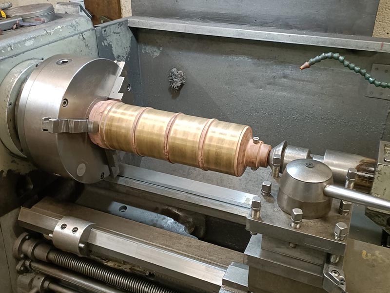 Slip ring component set up in a lathe and being machined to a clean surface