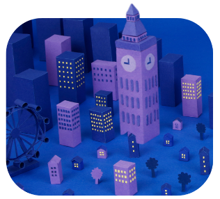 Stylized miniature cityscape with a clock tower, ferris wheel, and various buildings illuminated with yellow lights against a blue background.