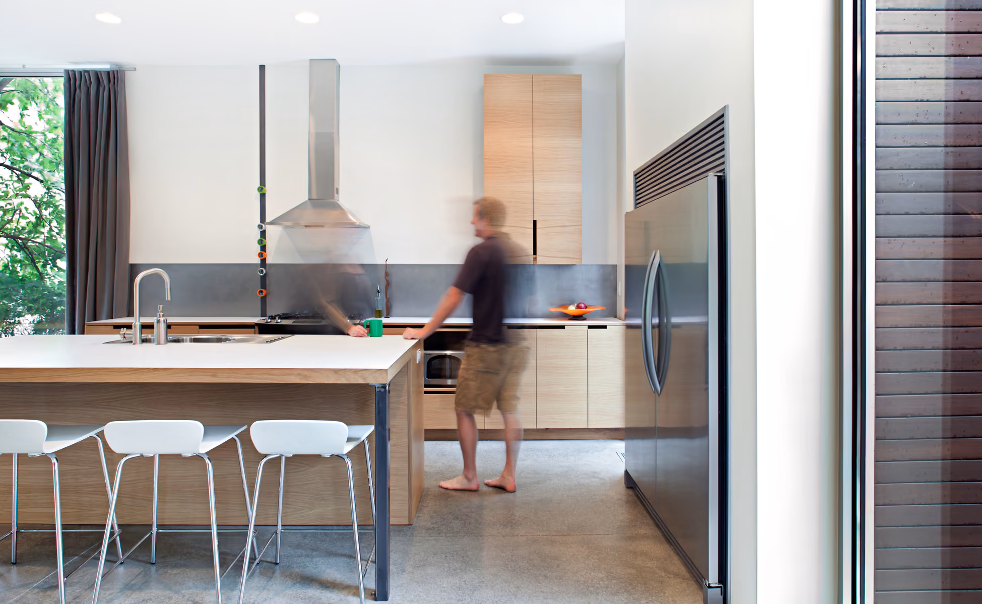 Custom kitchen with polished concrete floors and white oak cabinetry by Faust Construction