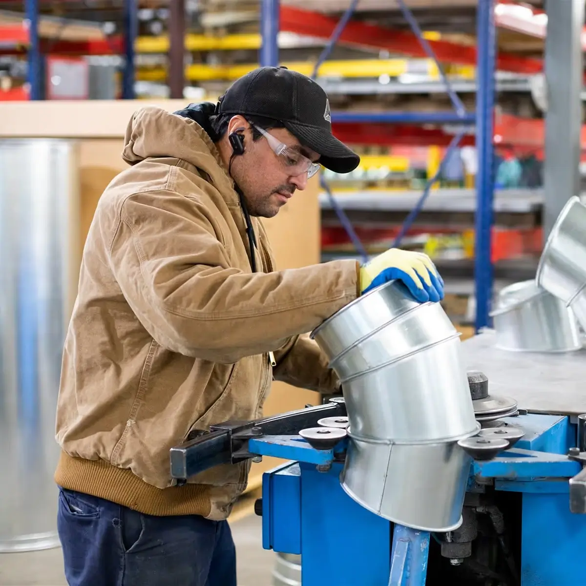 A worker checkinga a duct.