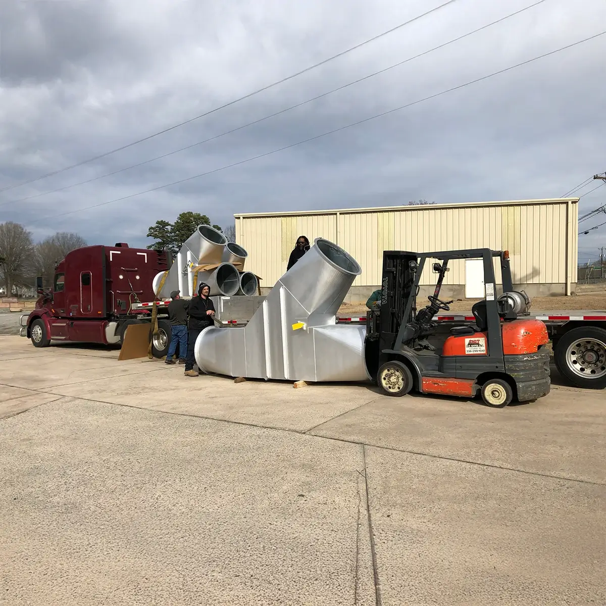 Very large diverter valves being loaded on a trailer.