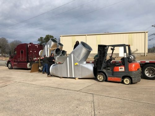 Very large diverter valves being loaded on a trailer.