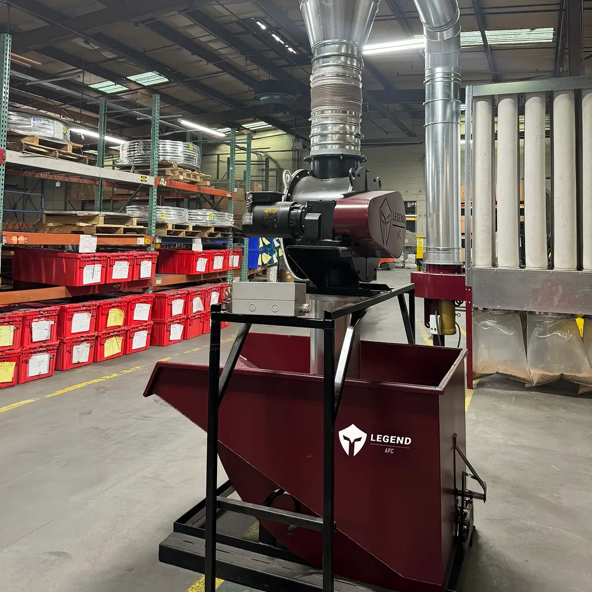 A Legend APC Open Baghouse, Inline Separator, Rotary Airlock, and Self-Dumping Hopper connected with ductwork in an industrial facility.