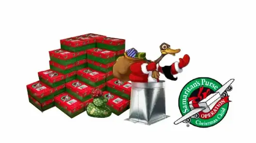 A duck surrounded by Operation Christmas Child shoeboxes and the OCC logo.