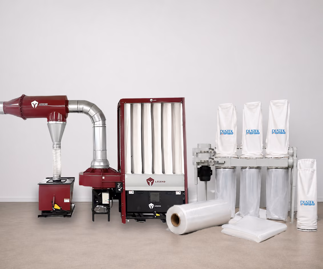 Industrial dust collection system with red Legend equipment and white Dustek filter bags on a beige floor.