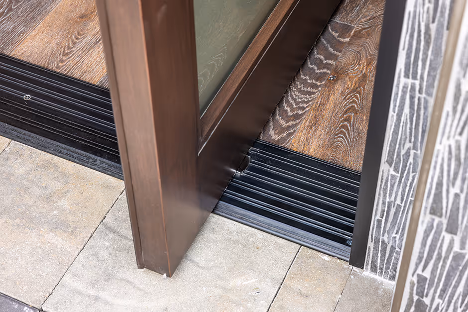 An up close perspective of an ADA sill with an AG Millworks pivot door hinge