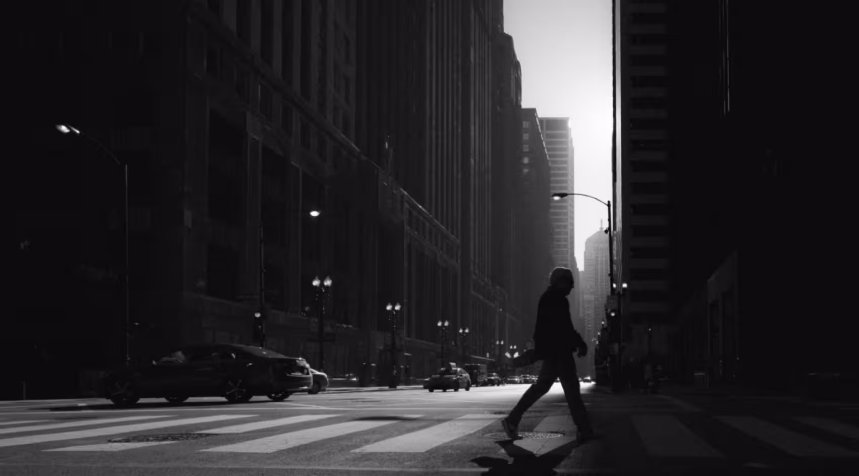 a person walking across an empty street