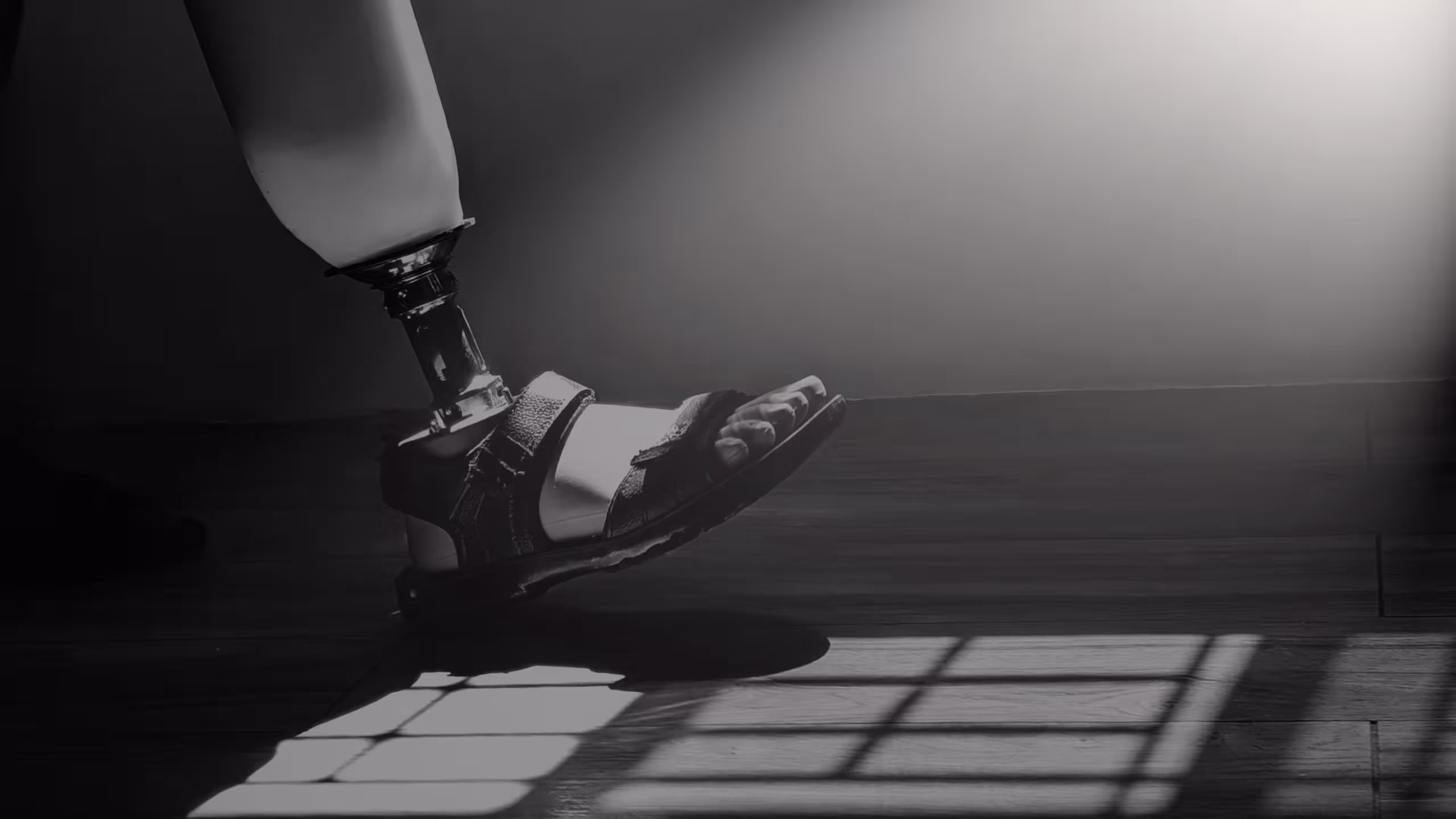 A person wearing a prosthesis and taking a step forward in beautiful lighting from a window