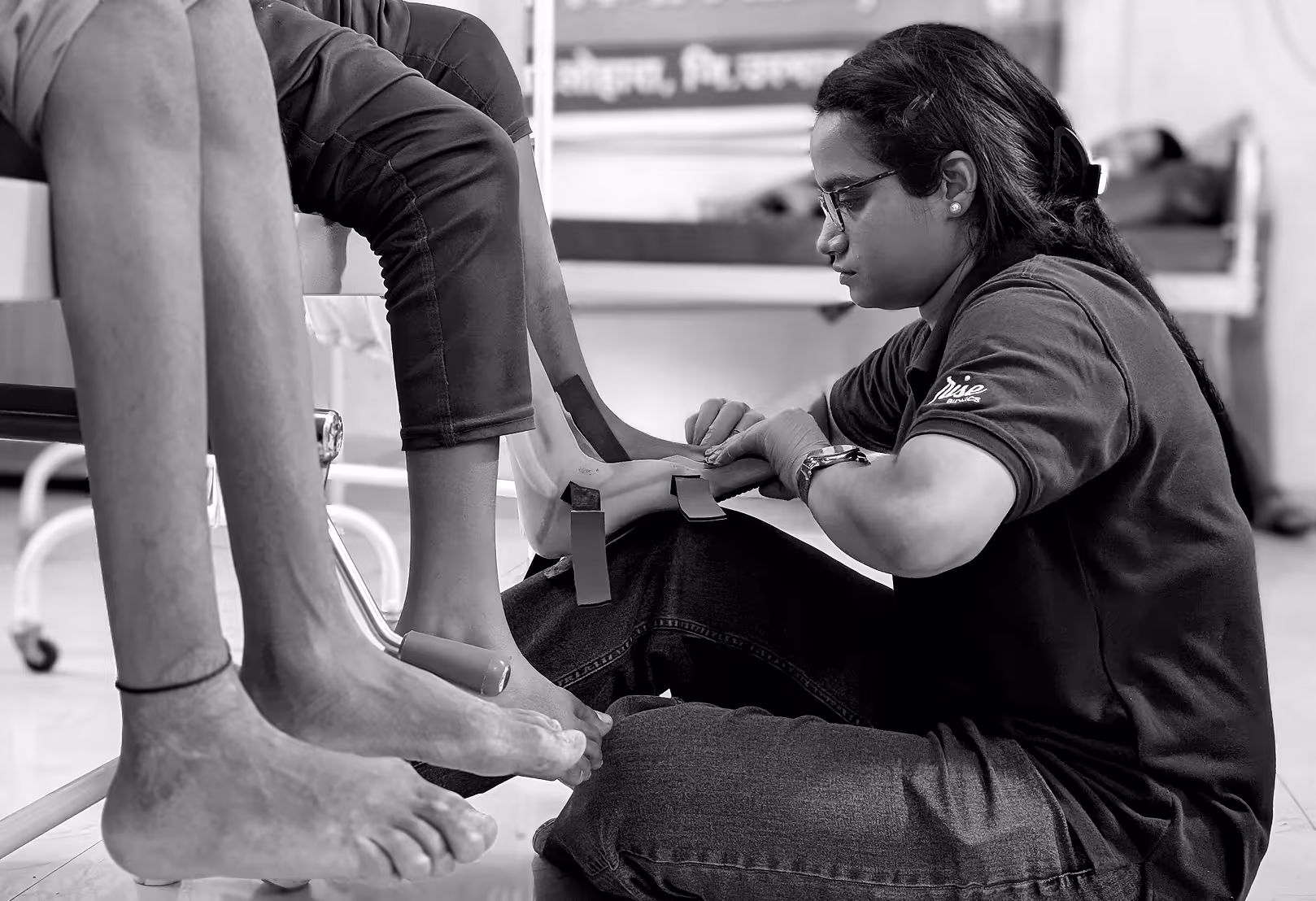 A prosthetist from Rise Bionics assessing and fitting a patient with an orthotic device