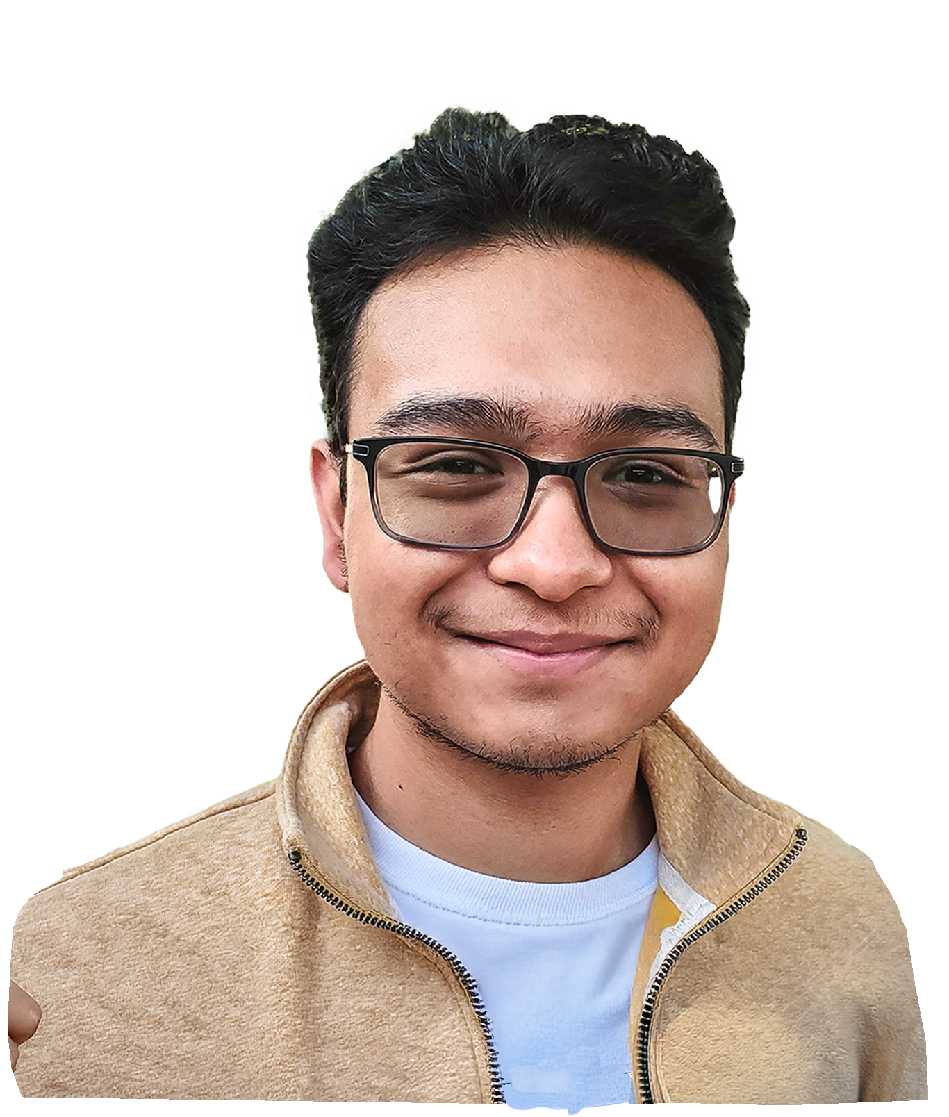 Smiling young man with short dark hair and glasses wearing a beige jacket and white shirt.