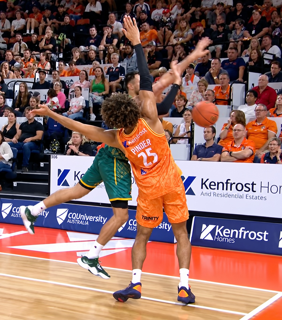 Cairns Taipans big man Keanu Pinder makes contact with Dakota Mathias' during three point attempt