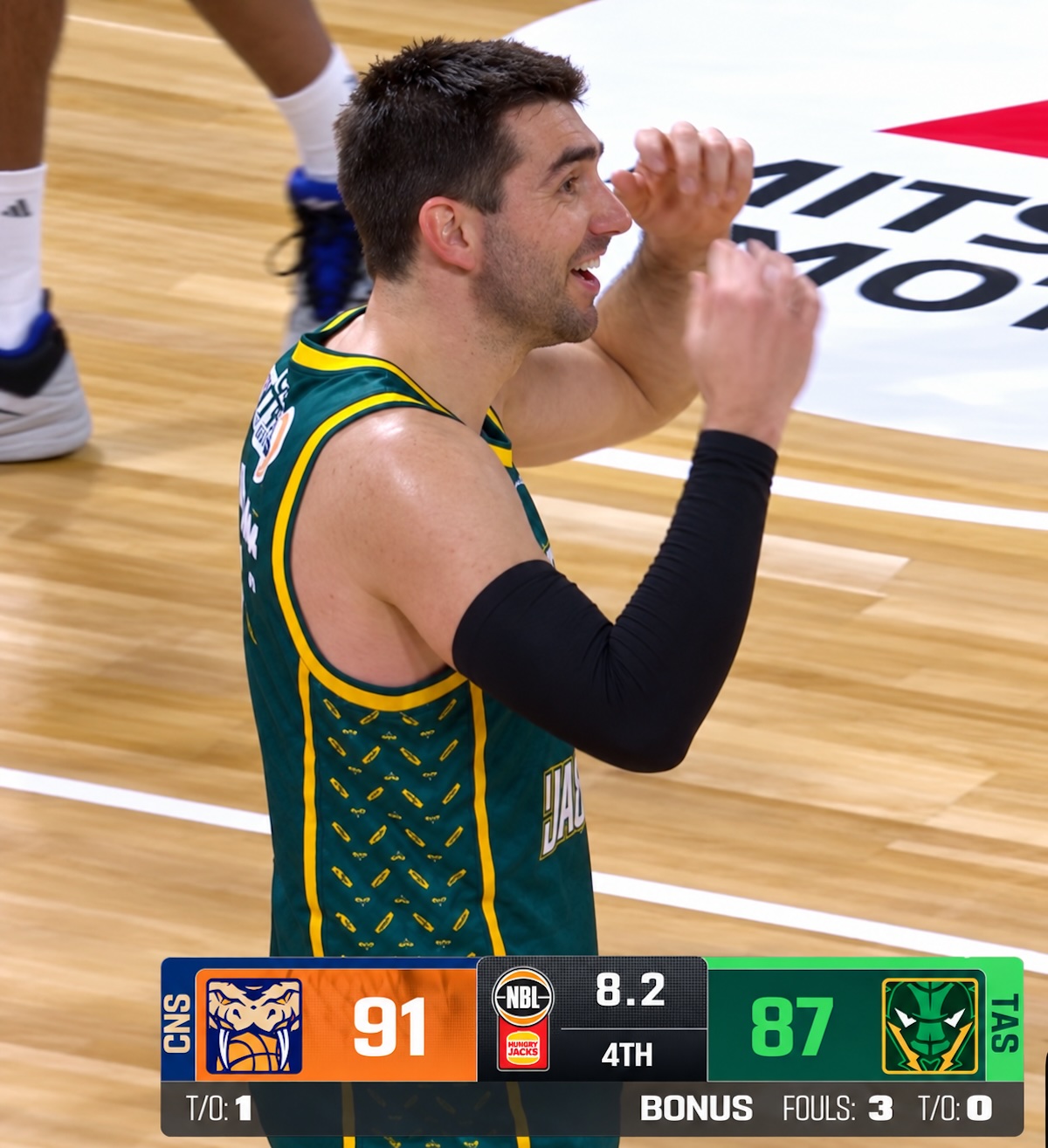 Tasmania JackJumpers Dakota Mathias is beguiled by the referees' decision not to call a foul on Keanu Pinder