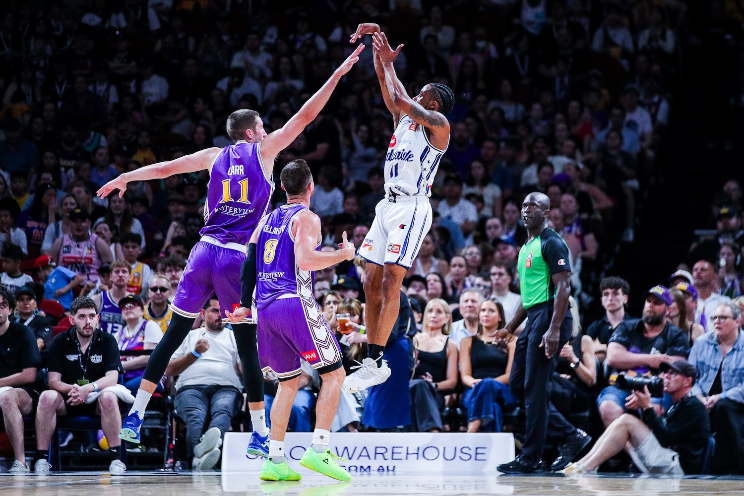 36ers guard Bryce Cotton shoots over the Kings' Andrew Carr and Matthew Dellavedova at Afterpay Arena in Sydney on October 11, 2026