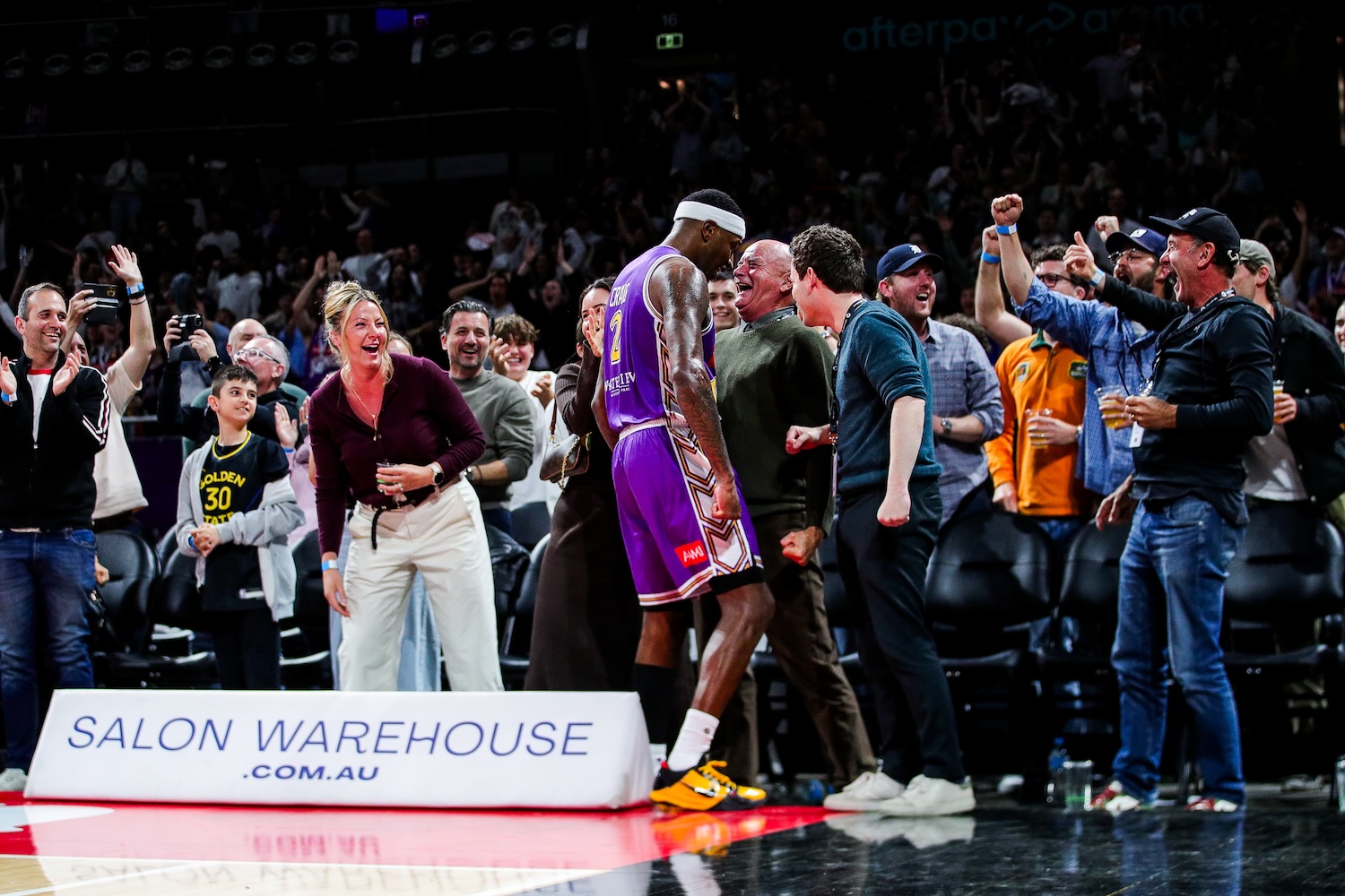 Kings forward Torrey Craig and owner Paul Smith celebrate face to face on the baseline after the game against the Perth Wildcats at Afterpay Arena in Sydney on October 17, 2026