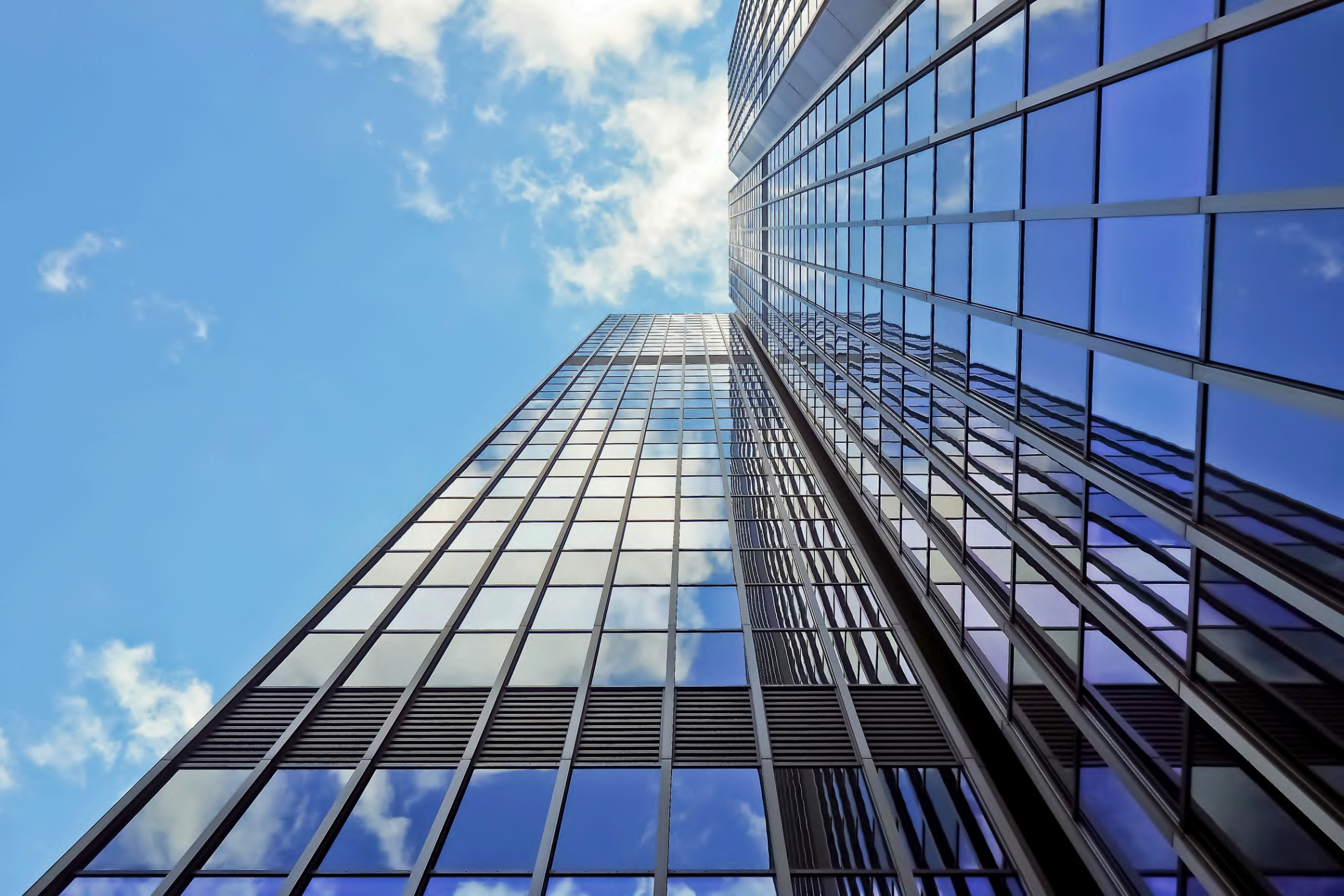 Modern multi-storey building façade viewed from below