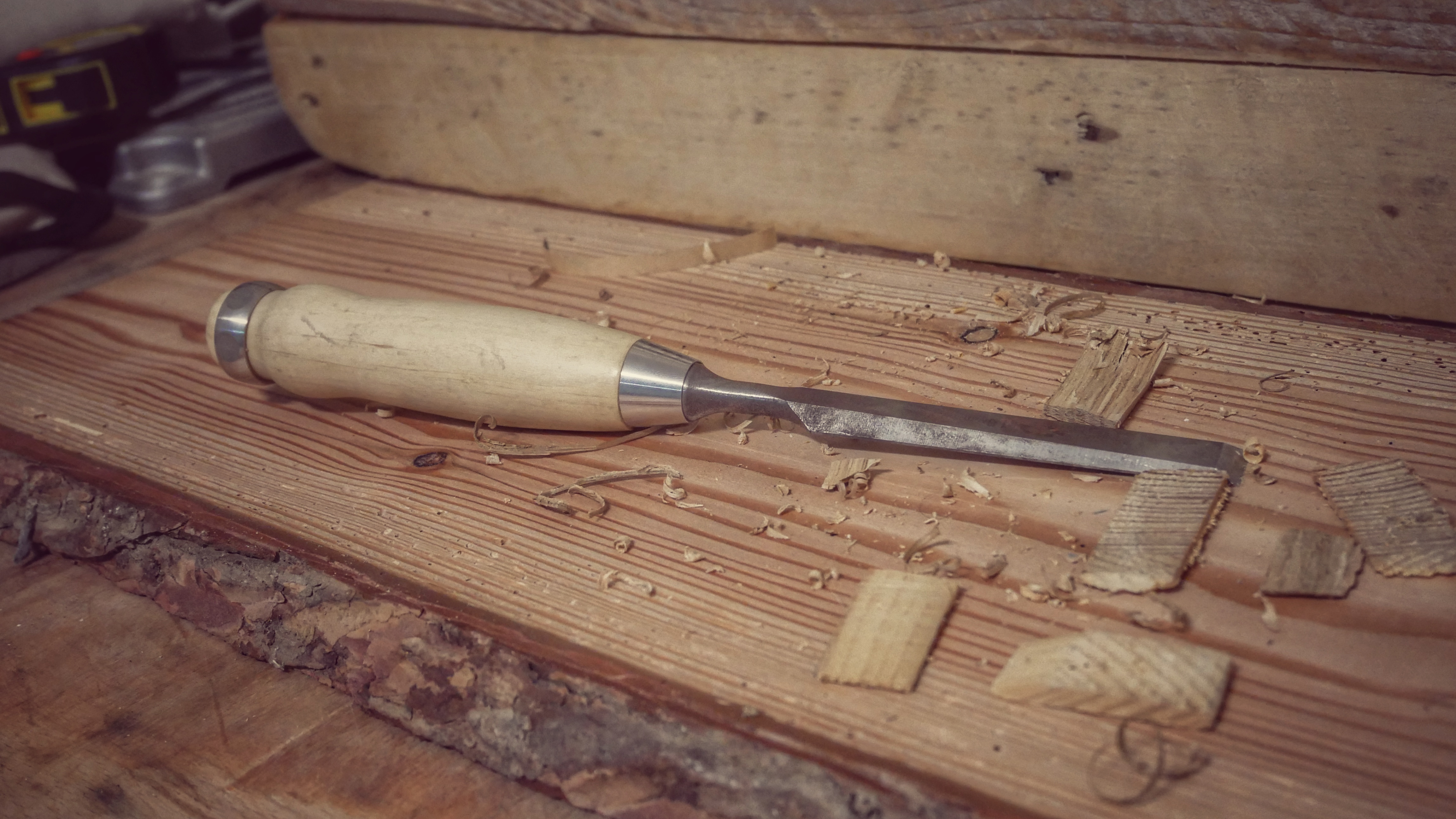 Chisel carving into wood for fine detail work, a vital hand tool for woodworking projects.