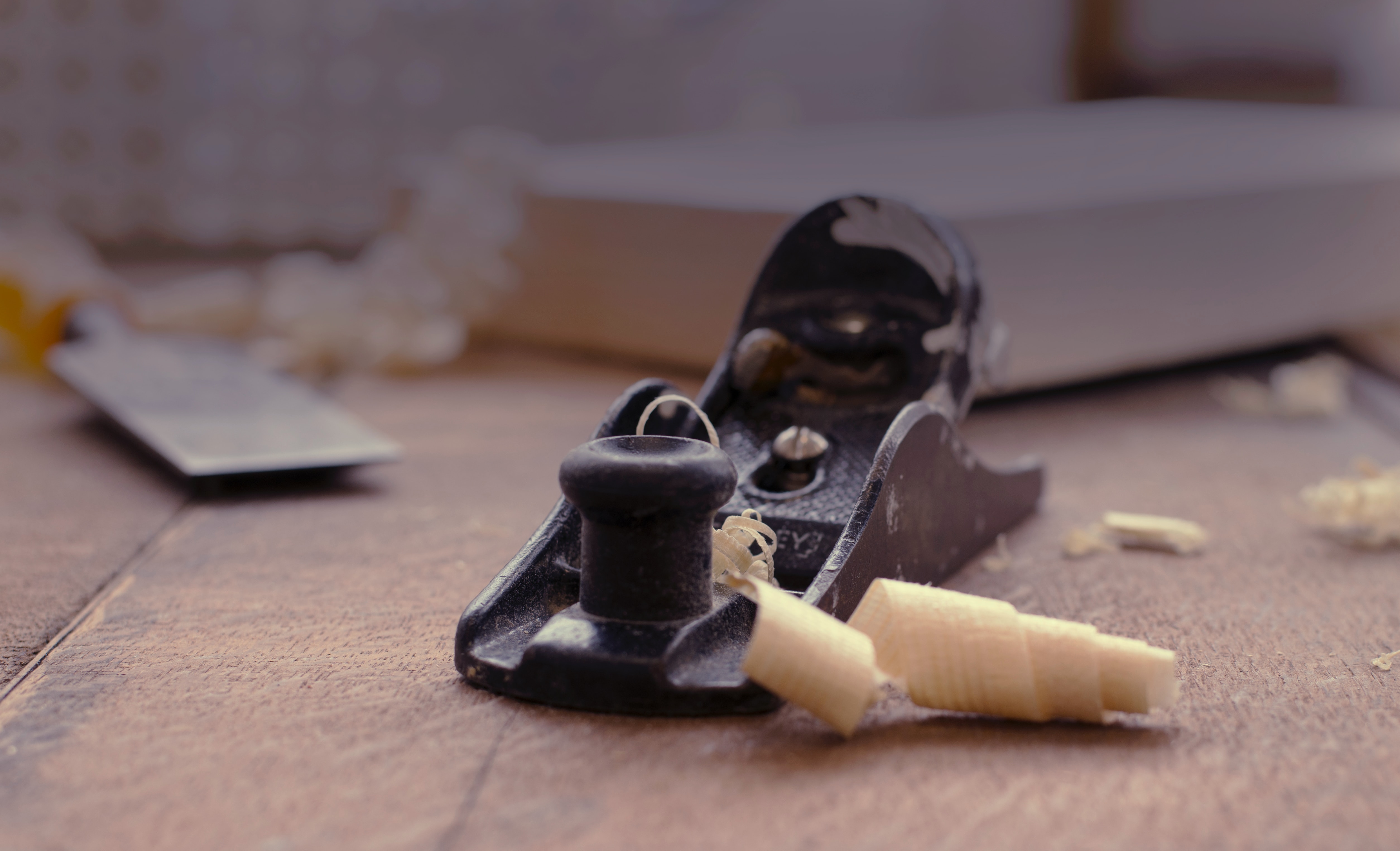 Woodworker can use a hand plane to smooth and shape wood, a fundamental tool for fine woodworking.