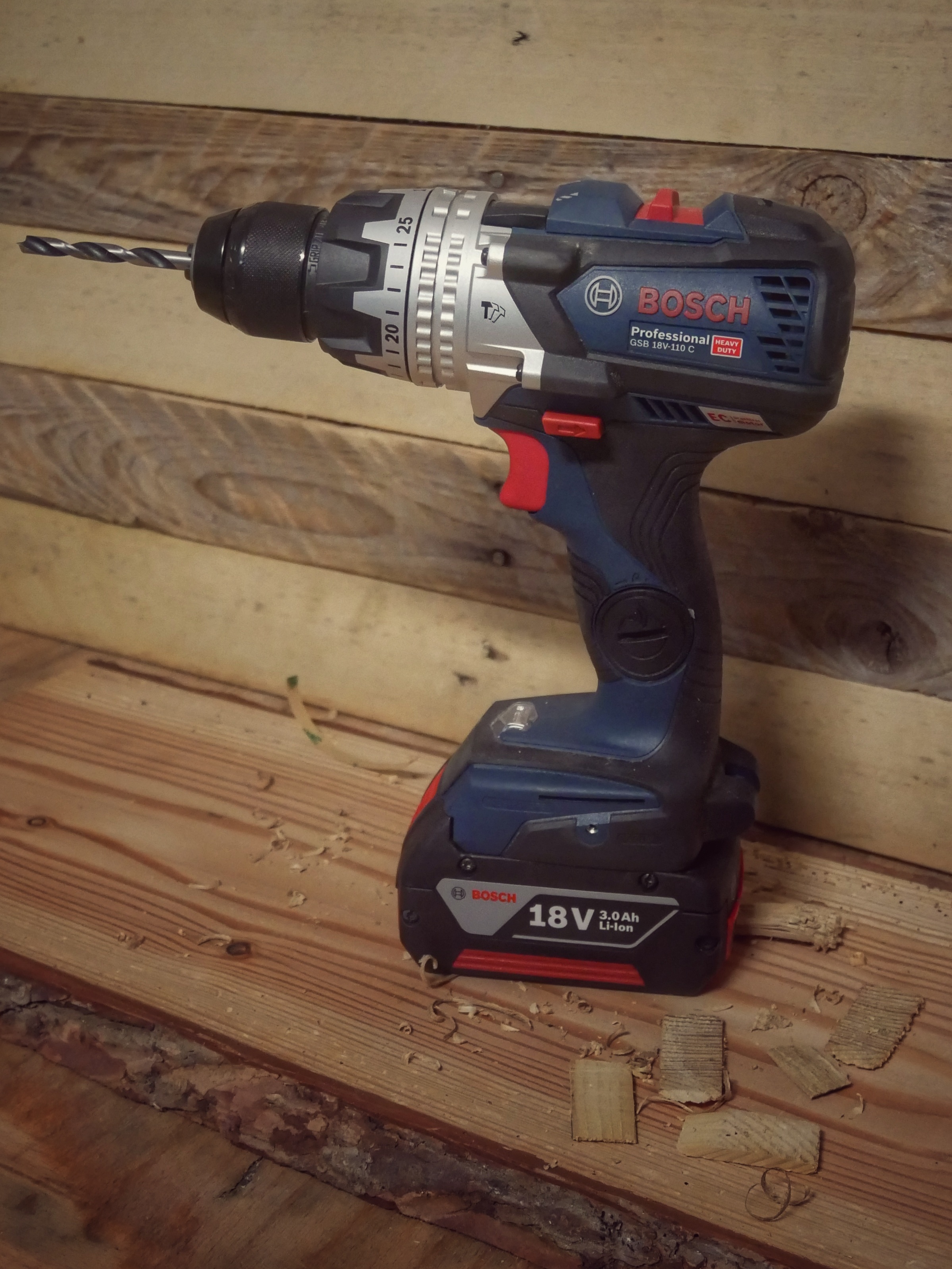 Cordless electric drill on a wooden surface, a must-have tool for DIY woodworking projects.