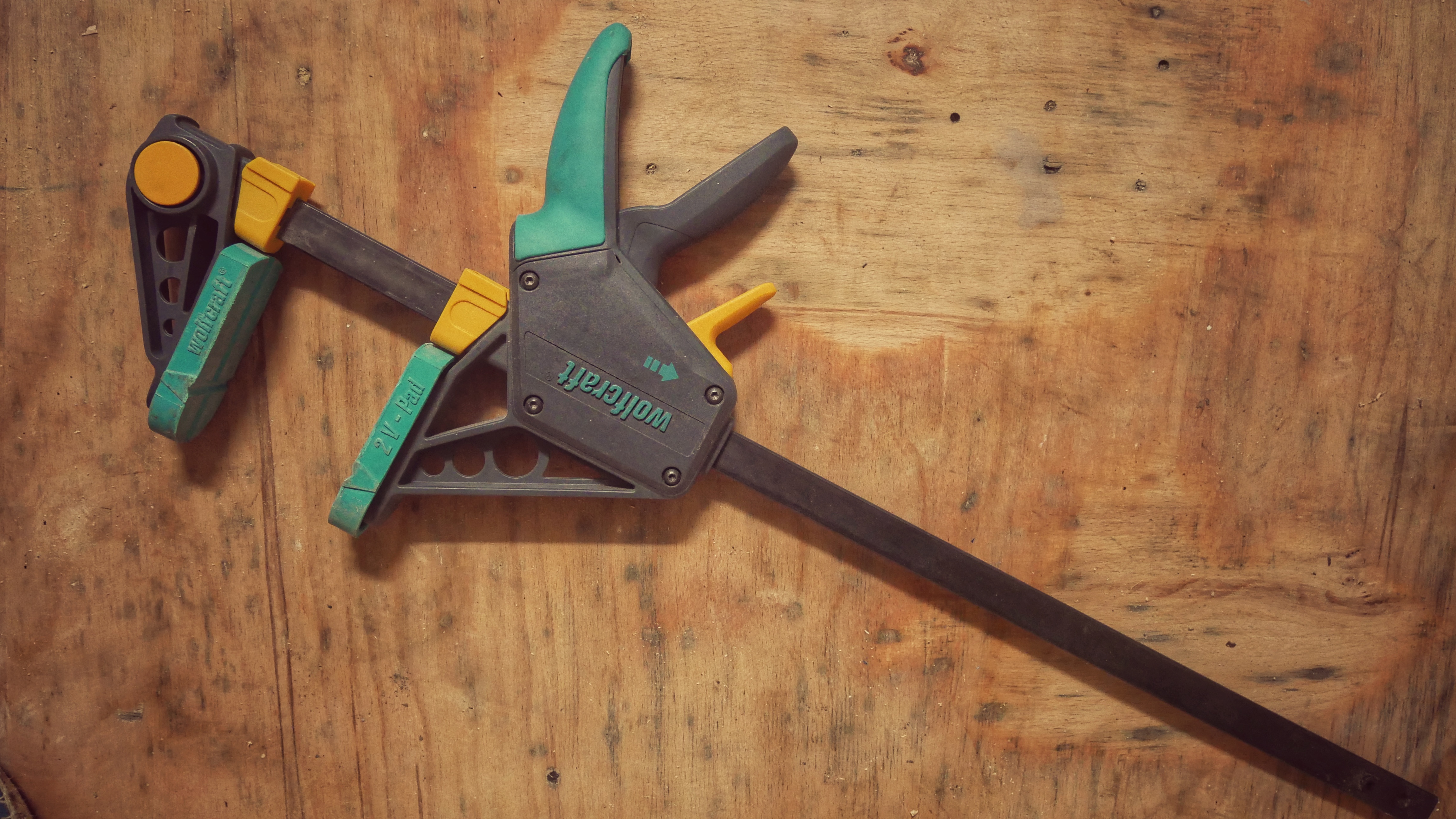 F-style clamps  to hold wooden pieces together during assembly in a DIY woodworking project.