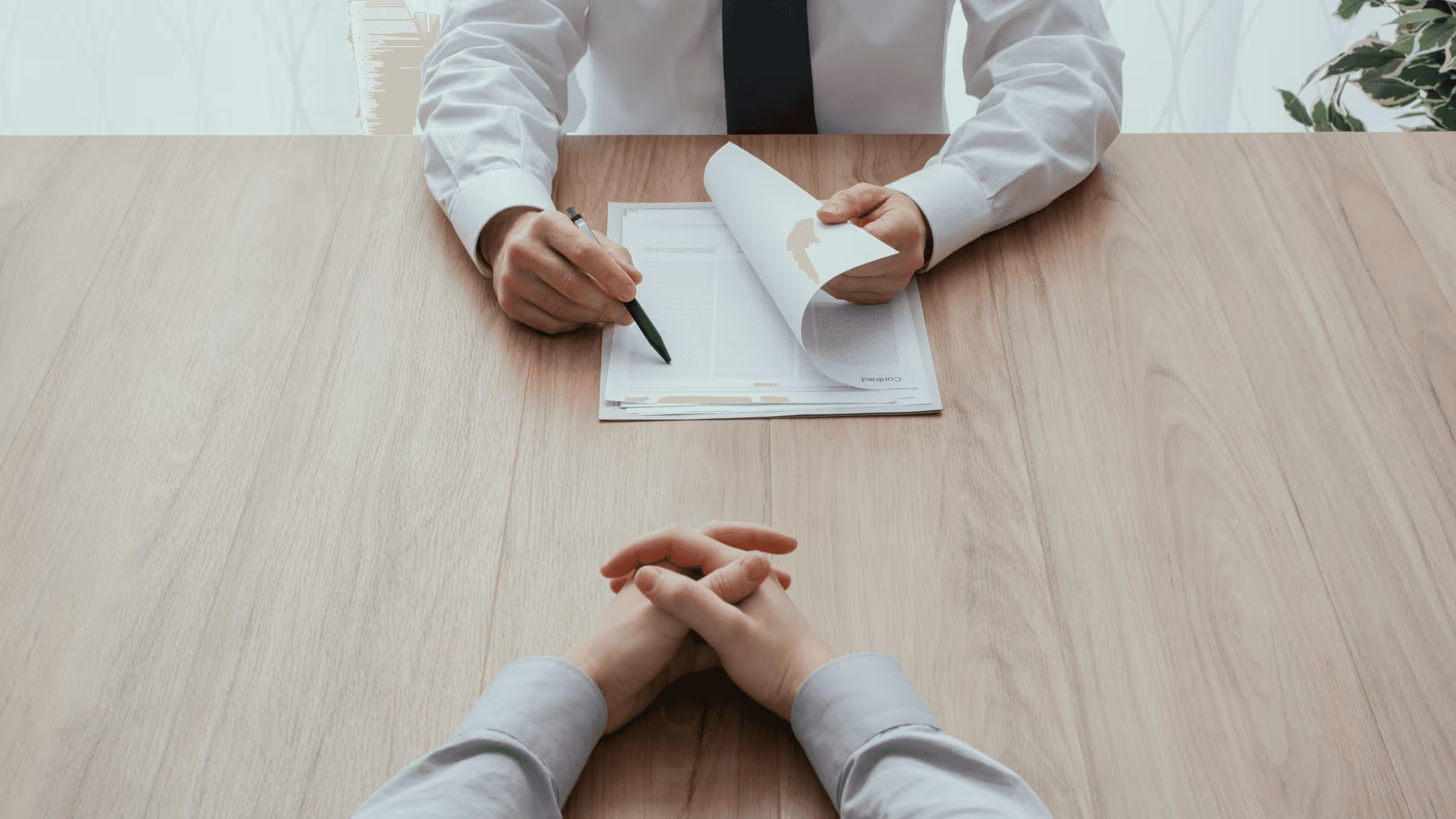 Two people sitting across each other during a job interview.