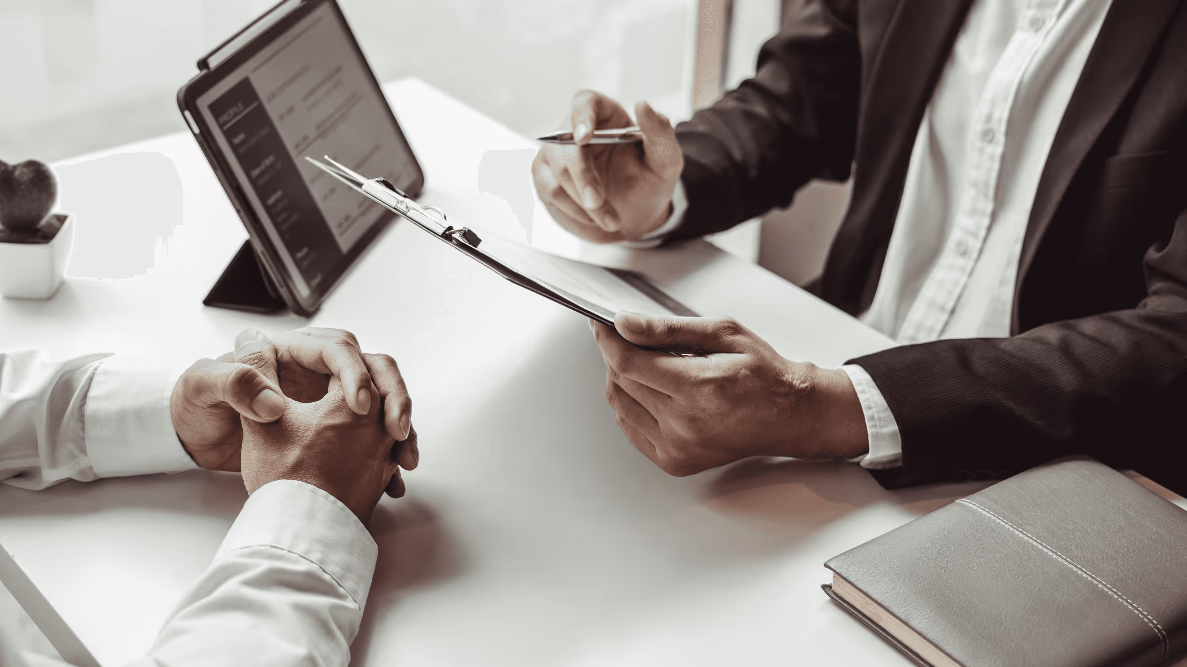 An interviewer assessing the resume and application of the interviewee.