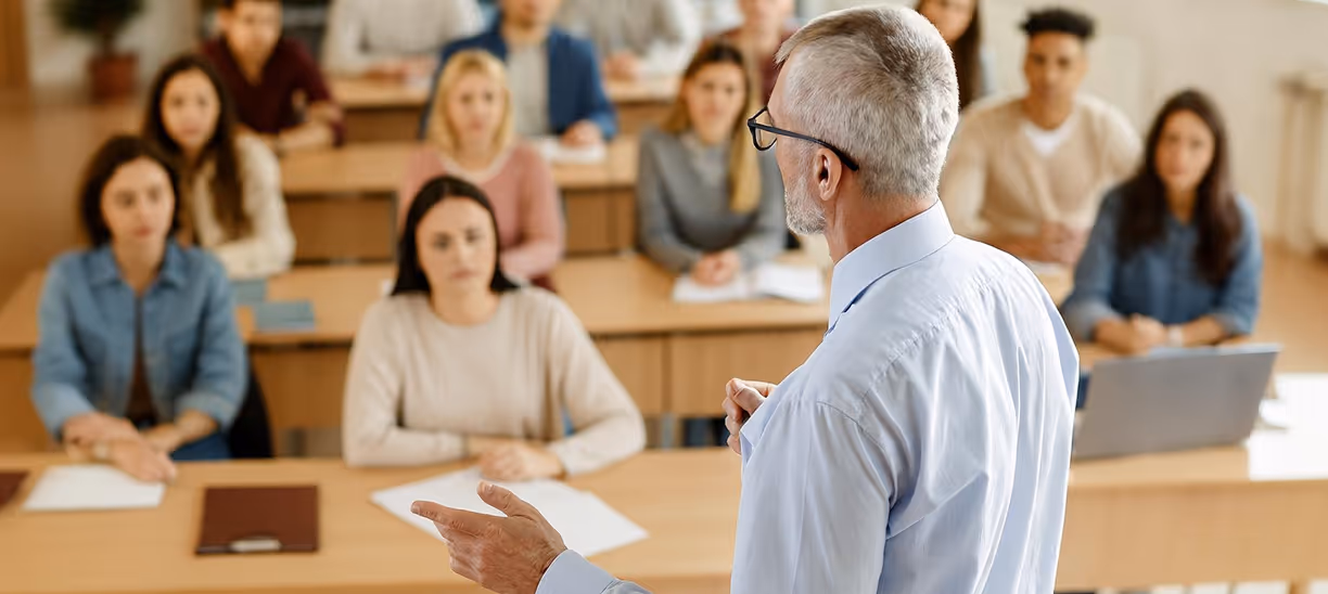An MRI professor holding a lecture in a classroom full of MRI students