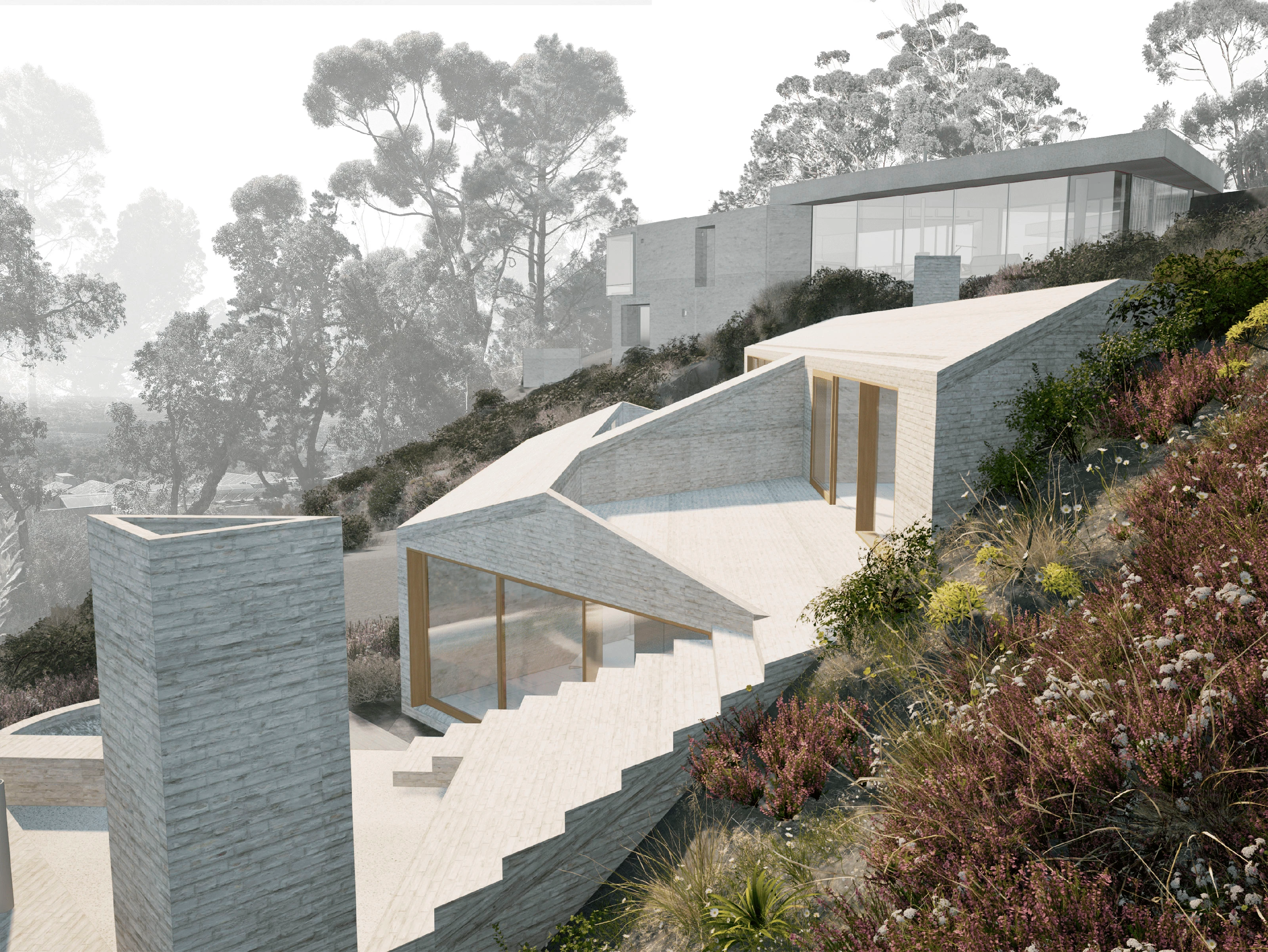 Modern terraced stone house with large glass windows on a sloped hillside with wild vegetation.
