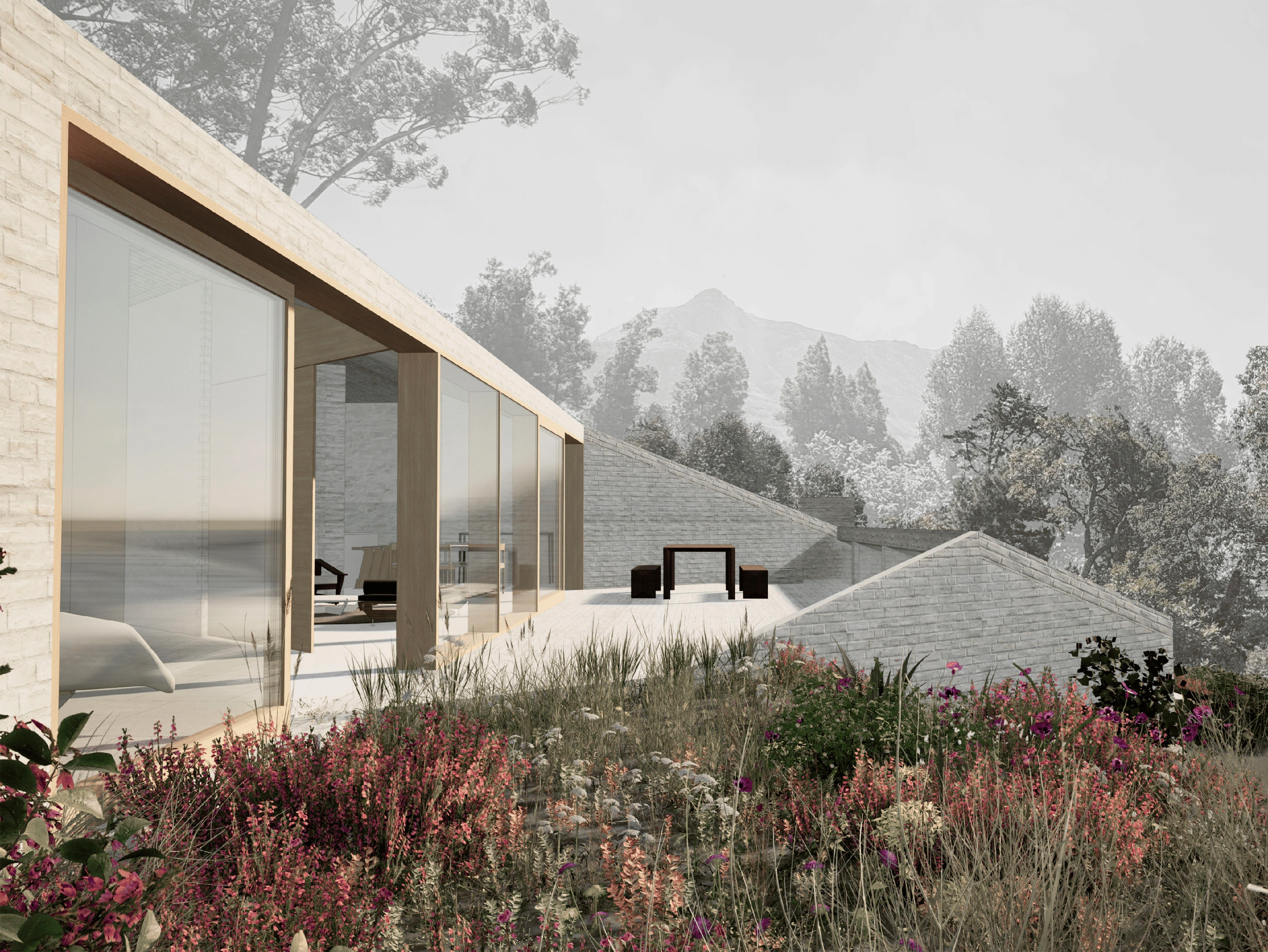 Modern house with large glass windows overlooking a garden with wildflowers and distant mountains.
