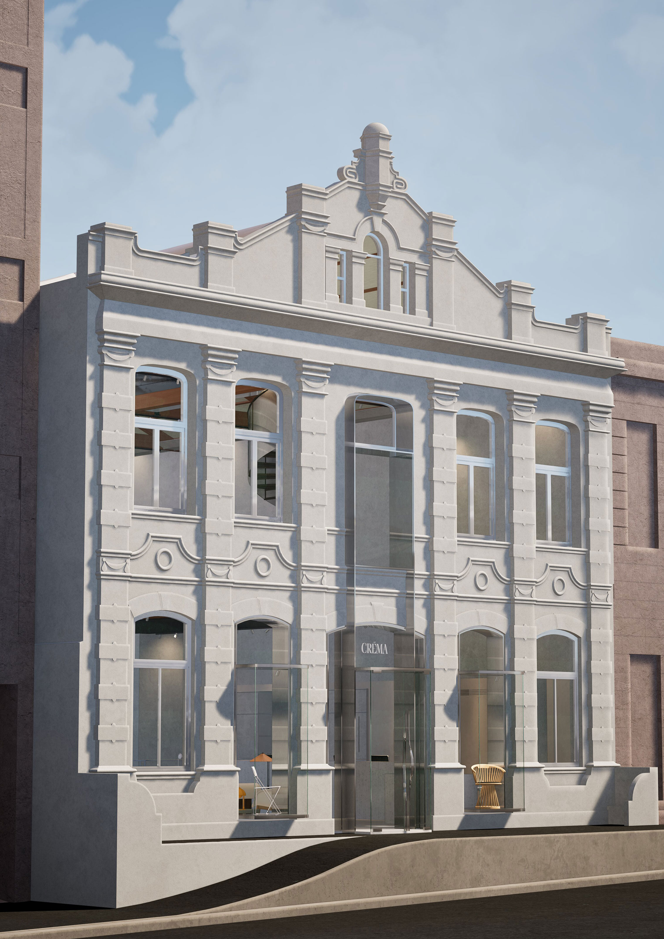 Historic two-story cream building with ornate details and glass entrance displaying 'CRÈMA' sign.