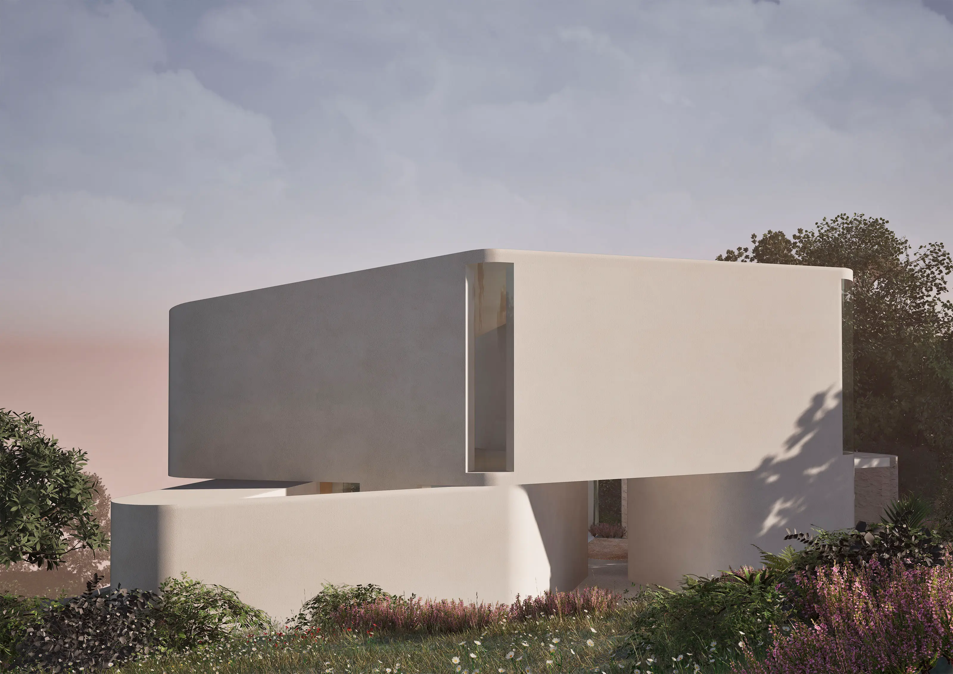 Modern curved white building surrounded by greenery and flowers under a cloudy sky at dusk.