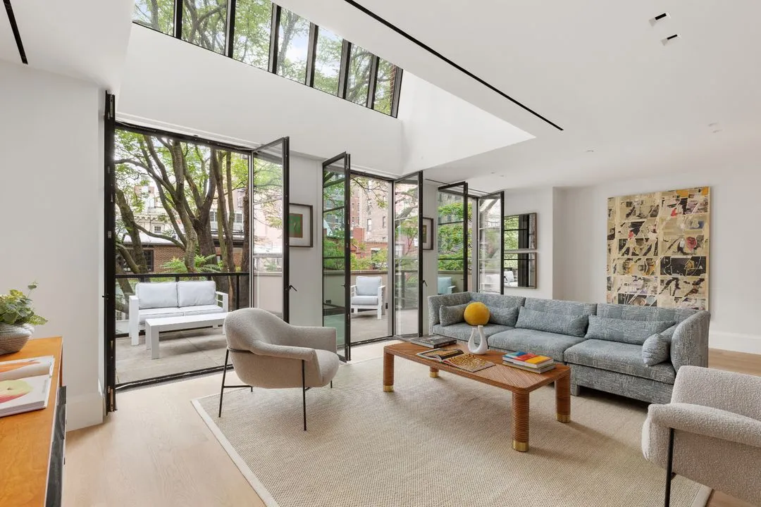 media room with skylight and and doors open to terrace