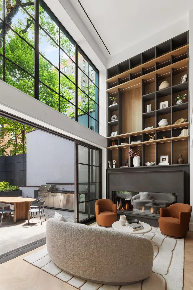 View of bookcase and large garden window in den