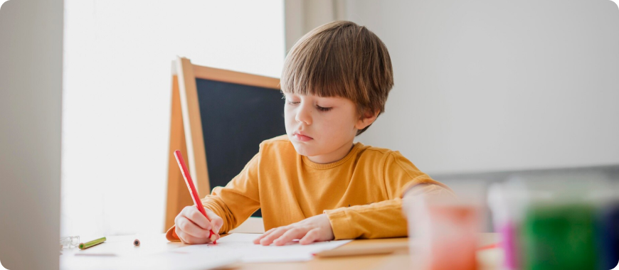Children doing fun English writing exercises with worksheets