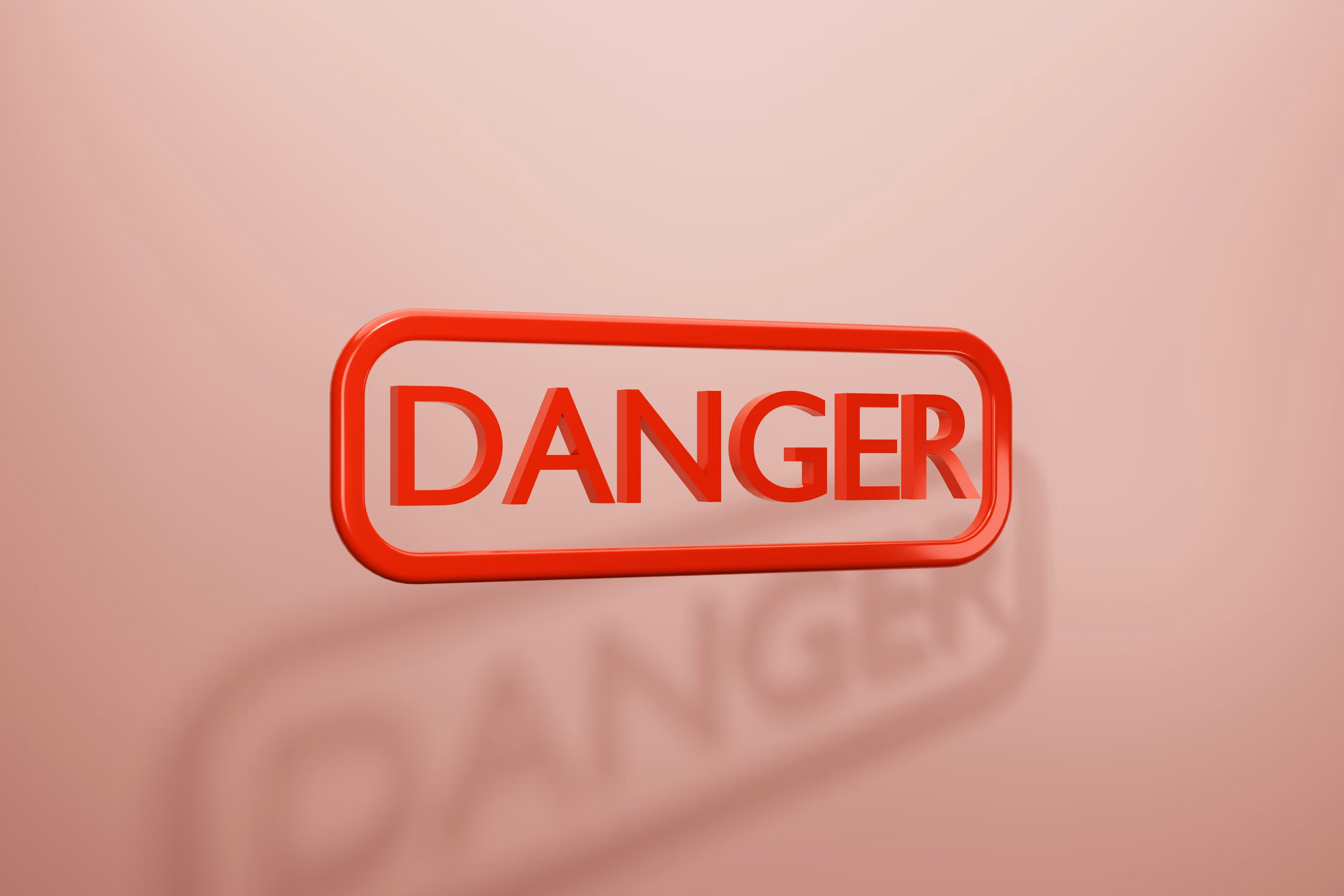 Panneau d'avertissement rouge avec le mot "DANGER" en 3D. Représente un risque ou une mise en garde liée à l'alopécie en France.