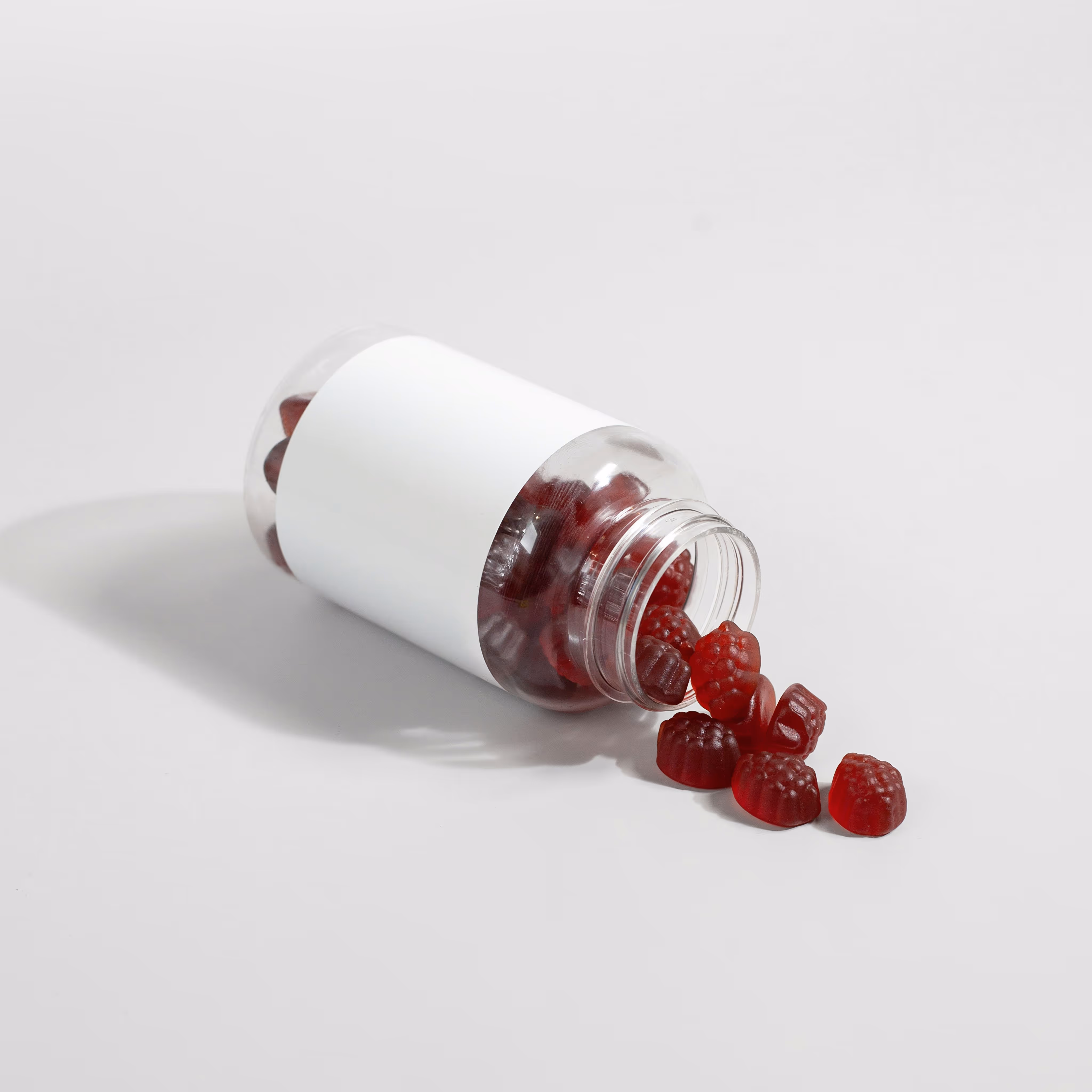 Gummies pour cheveux : bonbons vitaminés rouges en bouteille pour croissance capillaire.