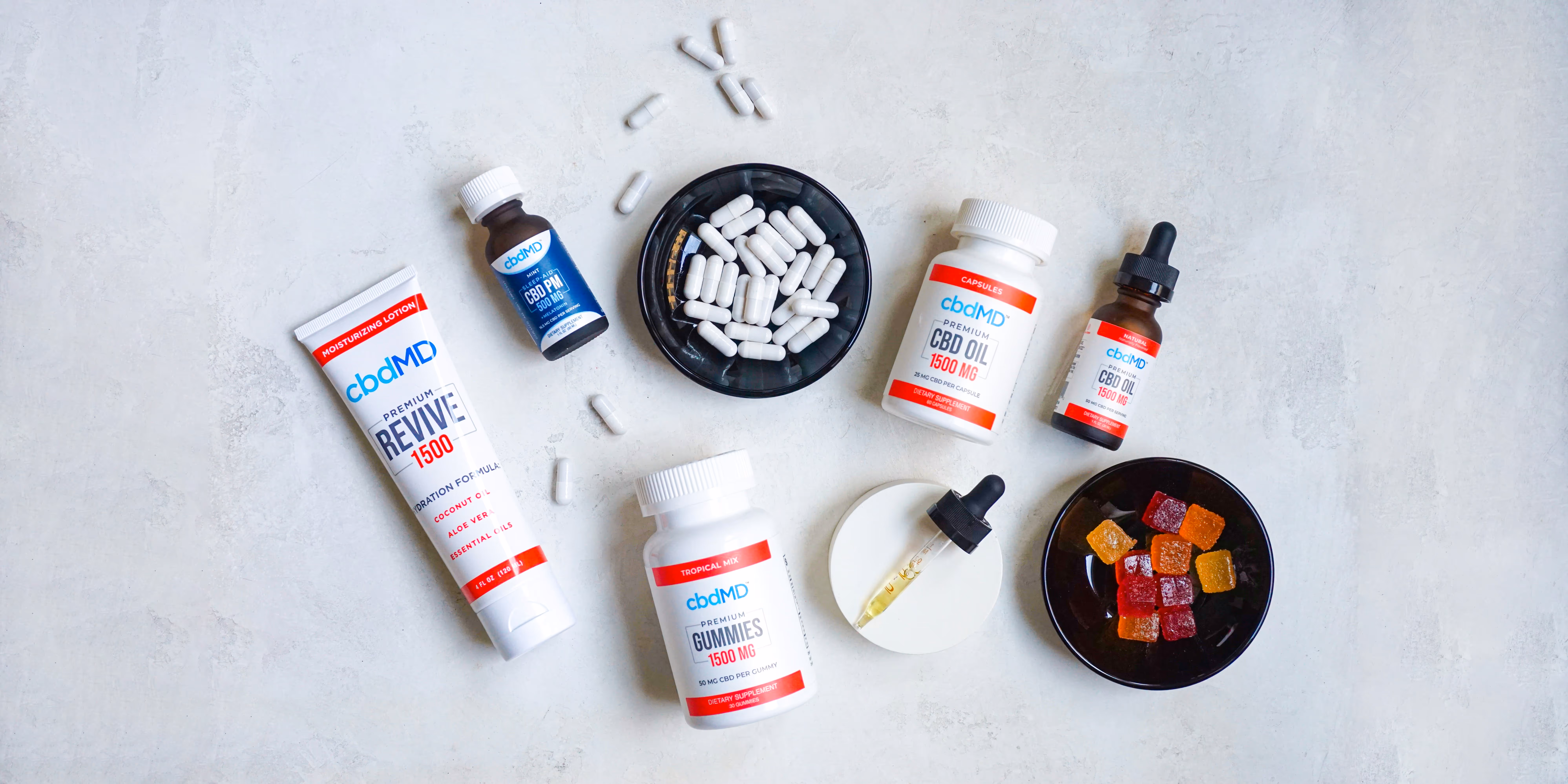 Assortiment de produits CBD premium cbdMD: huiles, capsules, gommes et lotion. Solutions pour le bien-être et le soin capillaire.