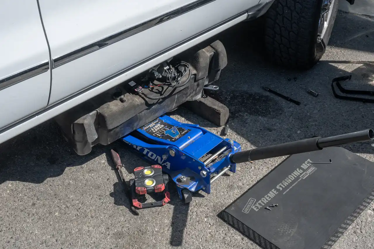 Roadside repair service on a heavy-duty truck with fuel tank removed for on-site diagnostics and emergency maintenance.