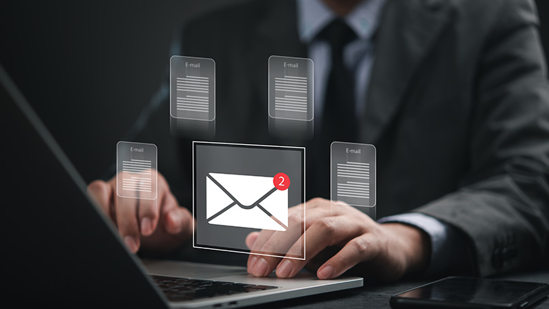 Email icon with alert on laptop screen in corporate workspace, concept of business inbox management, notification system and email marketing software.