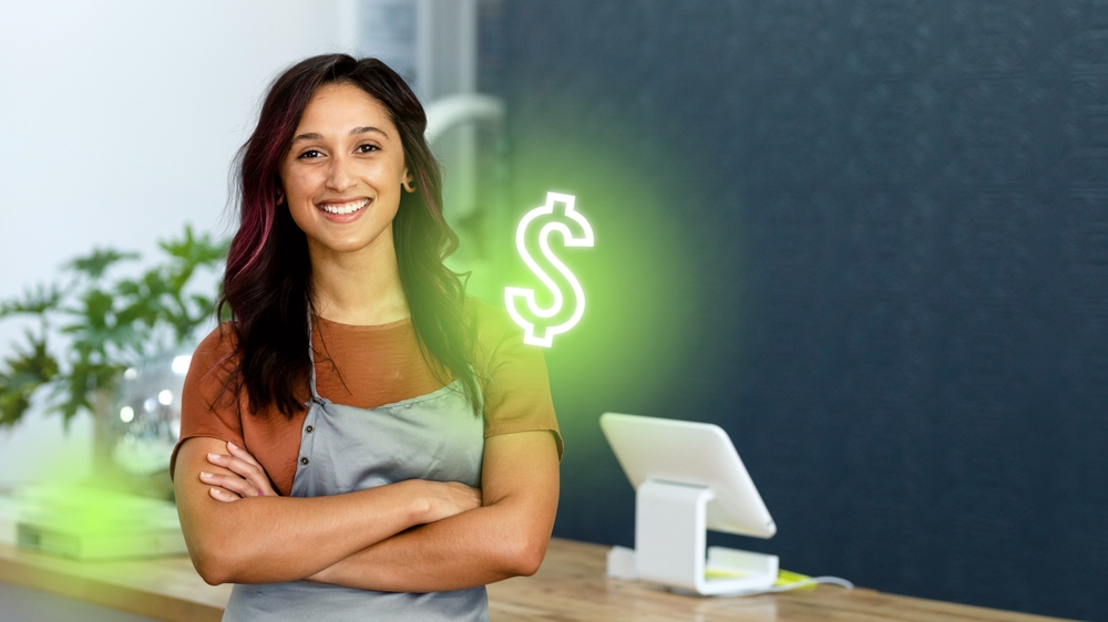 Smiling business woman, arms crossed, in apron.