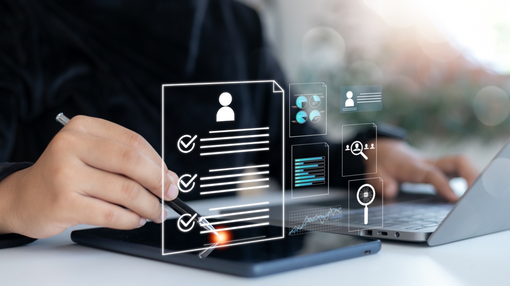 HR professional analyzing a digital resume on tablet with data charts