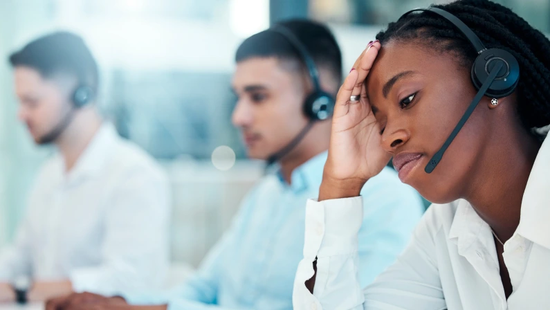 Headache, call center and burnout with a black woman in telemarketing looking tired or exhausted. Consulting, compliance and customer service with health issues of a female crm representative
