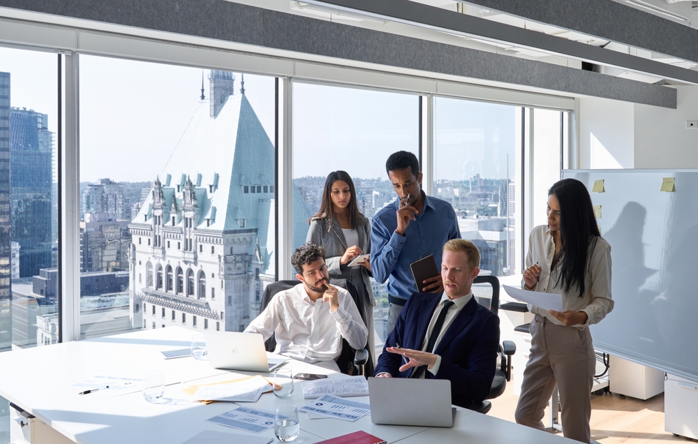 Busy diverse professional business people using laptop