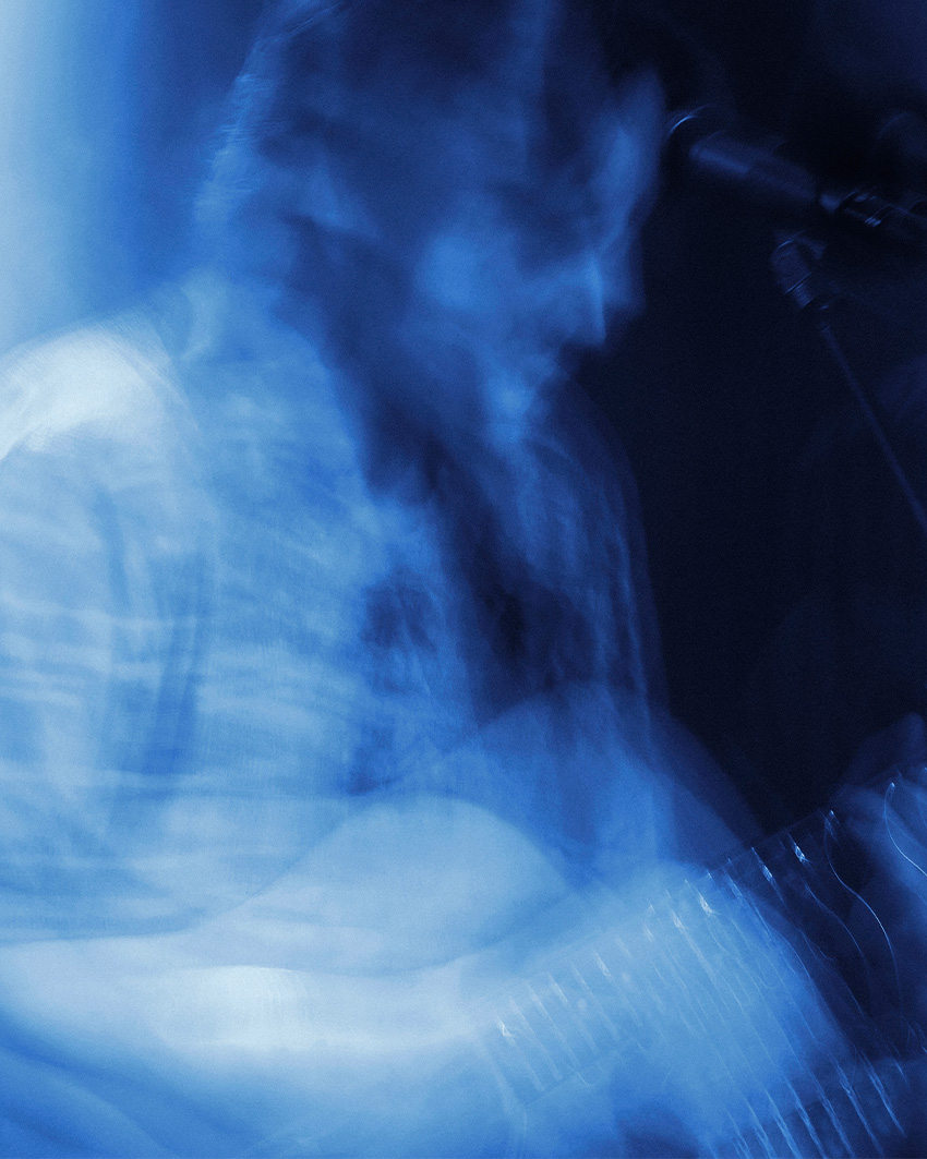 Ethereal close-up of a musician's hands on a guitar, emphasizing the fast-paced motion of a live performance by Patrick Pankalla.