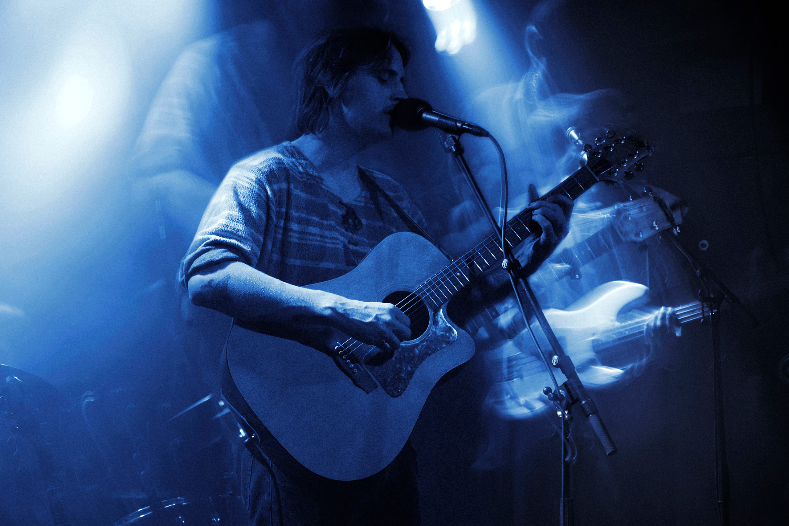 Thoughtfool vocalist singing with a handheld microphone during a live show at Rust in Copenhagen.